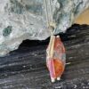 This is a highly polished Hematoid stone. Shaped as a merkabah and set in stirling siler it is truly beautiful. thecrystalcave.com.au