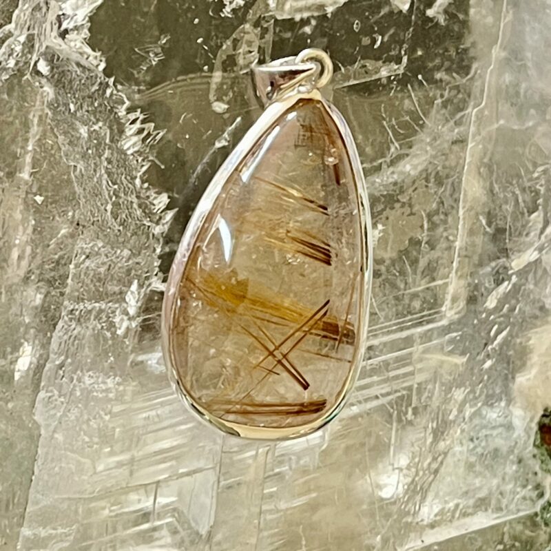 This is a beautiful Tear drop shaped golden rutile cabochon pendant. It is set in 925 silver. thecrystalcave.com.au