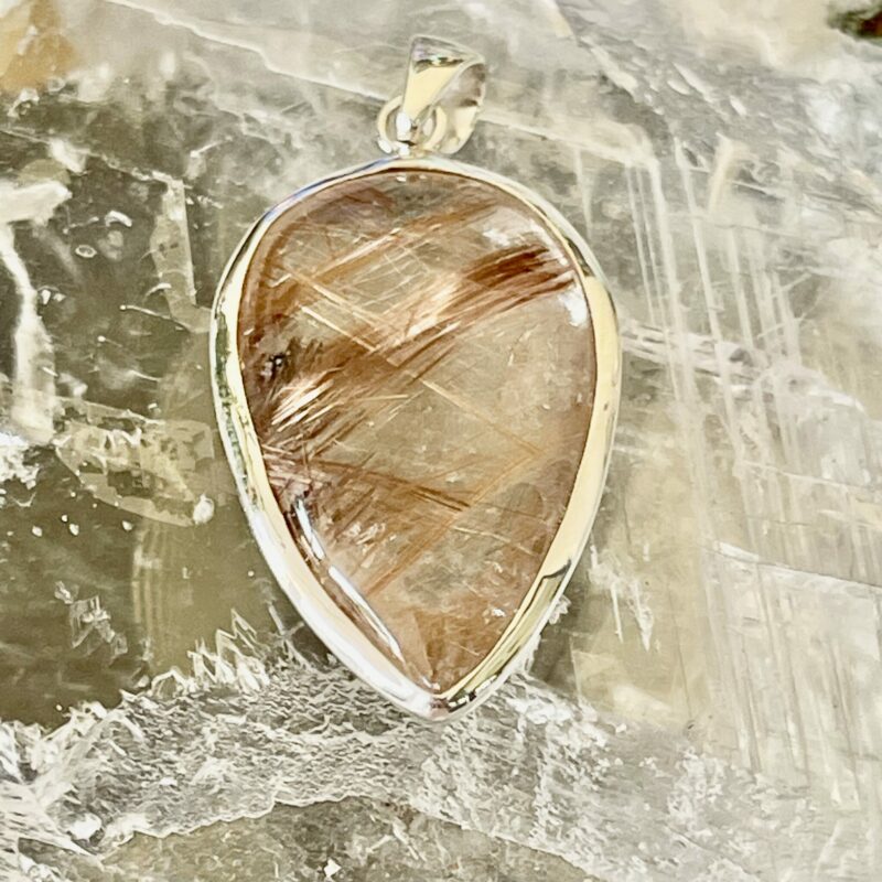 This is a beautiful Tear drop shaped golden rutile cabochon pendant. It is set in 925 silver. thecrystalcave.com.au