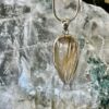 This is a beautiful Tear drop shaped golden rutile cabochon pendant. It is set in 925 silver. thecrystalcave.com.au