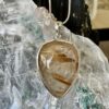 This is a beautiful Tear drop shaped golden rutile cabochon pendant. It is set in 925 silver. thecrystalcave.com.au