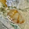 This is a beautiful Tear drop shaped golden rutile cabochon pendant. It is set in 925 silver. thecrystalcave.com.au